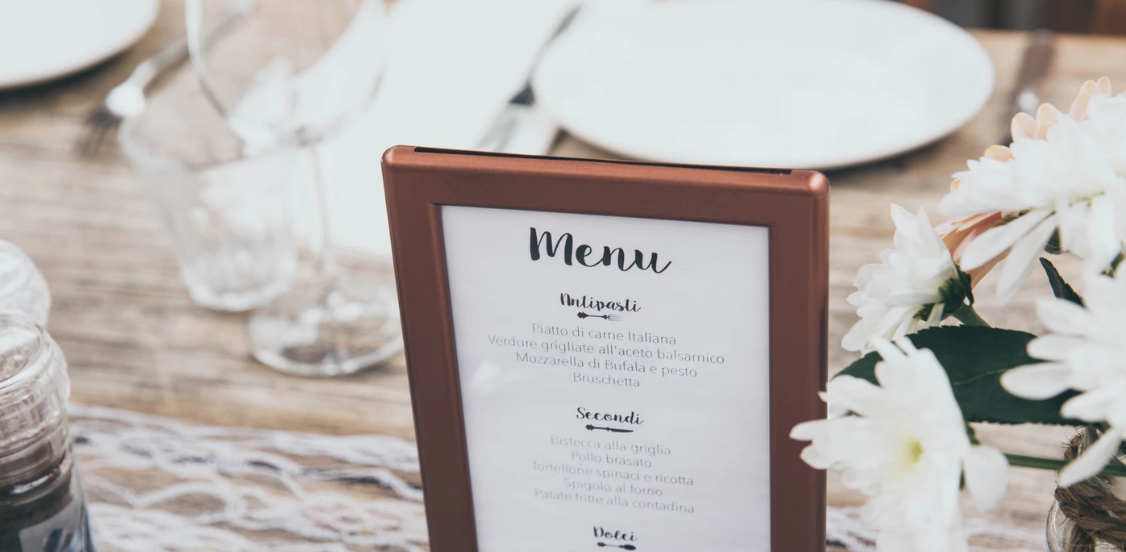 A menu in a sign on a table