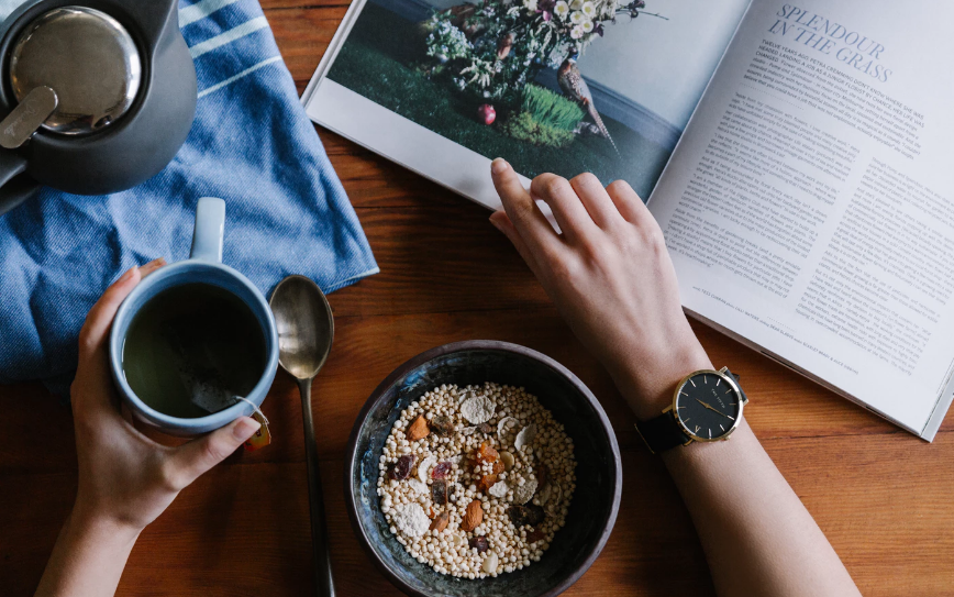 Reading a magazine with breakfast